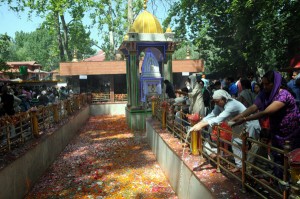 Devotees pour milk into sacred spring during the annual festival at the Kheer Bhawani Temple at Tulla Mulla in Ganderbal on Friday. -Excelsior/ Amin War