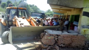 An encroachment being demolished at Ramban on Saturday.