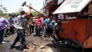 JMC officials removing encroachments on Tuesday. 