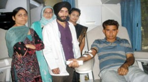 A volunteer donating blood during a blood donation drive organized by IRCS, Jammu region, at JU Campus on Tuesday.