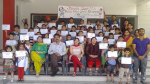 Children holding certificates while posing for a group photograph during concluding ceremony of Summer Camp at DPS in Udhampur.