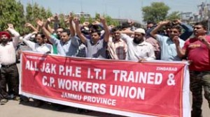 Protesters of J&K PHE ITI Trained and CP Workers Union holding protest on Monday.  -Excelsior/Rakesh