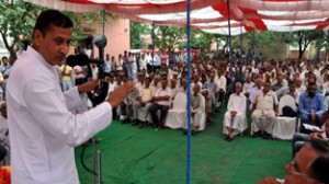 Minister for PHE Sham Lal Sharma addressing public meeting at Akhnoor on Sunday. 