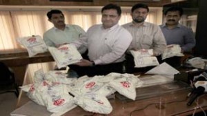 JMC Commissioner Kiran Wattal showing seized milk  powder packets at Jammu on Saturday. -Excelsior/Rakesh 