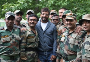 Bollywood actor Javed Jaffri poses for a photograph with soldiers during shooting for his upcoming Malayalam film in Shopian district on Thursday.-Excelsior/Younis Khaliq