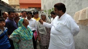 Minister for Housing, Raman Bhalla interacting with locals at Jammu on Friday.