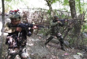 Security forces retaliating firing by militants trapped in a house at village Aripal, Tral in South Kashmir district of Pulwama on Saturday. 