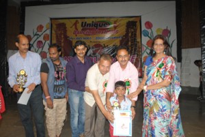 Young participant being felicitated during a Cultural Show organized by Unique Dancing Institute.