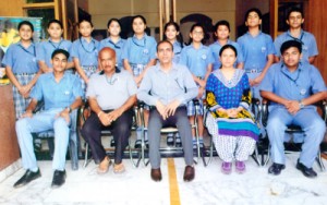 Medal winning swimmers of KC Public School posing for a group photograph alongwith the Principal and coaches.