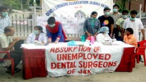 Dental surgeons examining passers-by during free dental checkup camp at Jammu on Saturday.