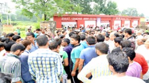 People block Tikri-Katra Road at Udhampur on Tuesday.