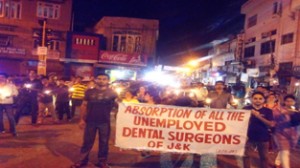 Dental surgeons raising slogans during candle march at Jammu on Tuesday.