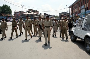 Senior police officers inspecting the spot after militants shot from point blank range a private security officer in Srinagar on Thursday.