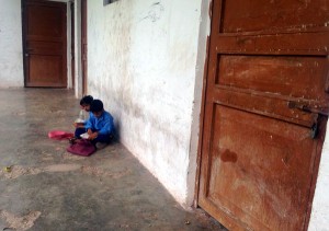 Two children sitting in ‘veranda’ of locked Govt. Primary School in Palma area of Rajouri on Wednesday.