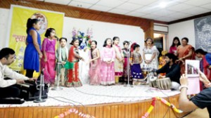 Students presenting cultural item while celebrating Janamashtami.