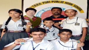 Students of SD Tara Puri School posing for a photograph  along with Principal and coach.