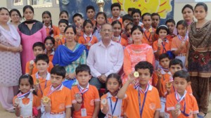 Winners of various events posing for a group photograph while celebrating National Sports Day at Sprawling Buds School in Jammu.