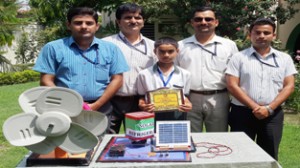 Winner Aditya Yadav displaying Hybrid Solar Refrigerator and Wind Mill alongwith staff members at HPS Bassi Kalan, Bari Brahmana in Jammu.