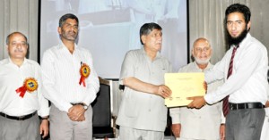 Minister for Higher Education, Mohd Akbar Lone felicitating winner during Inter-College Debate Competition. 