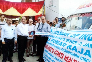 SBI officials donating an ambulance to representatives of Vitasta Hospital at Muthi on Tuesday.