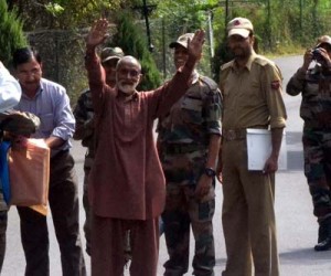 PoK citizen Mangta Khan waves towards the people before being handed over to Pakistan Rangers by the Indian officials during a flag meeting at the Kaman Post, Uri on Saturday.  —Excelsior/Aabid Nabi