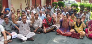 Clerical cadre employees staging protest outside Divisional Commissioner’s office in Jammu on Saturday. 