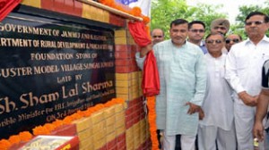 Minister for PHE, Sham Lal Sharma laying foundation stone of model village on Sunday.