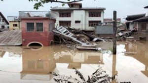 A collapsed house in Jawahar Nagar, Srinagar on Saturday. -Excelsior/Rakesh