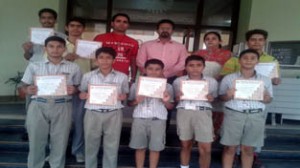 Participants of Inter-School Swimming Competition posing for photograph with Principal Dr Ravi Bhushan.