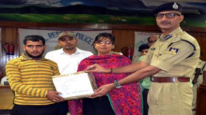 DDC, Yasha Mudgal and Commandant M K Sharma distributing relief material to a flash flood victim under operation “Ehaas” on Sunday.