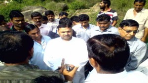 Ex-MP Madan Lal Sharma talking to people at relief camp in Rajouri.