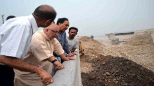 Minister for Roads and Buildings Abdul Majid Wani inspecting damage caused by flash floods to 4th Tawi Bridge on Sunday.