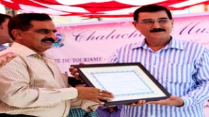 Director Tourism Soujanya Sharma handing over a certificate to Capt. Gour on Saturday.