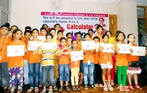 Students displaying certificates awarded by Career Abacus while posing for a group photograph. 