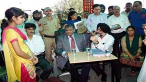 Chief Justice M M Kumar and Justice Virender Singh at a relief camp for flood victims.                      -Excelsior/ Rakesh