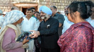 Executive Chairman SLSA Justice Virendra Singh distributing blankets among flood victims of Saddal village.