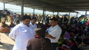 Minister for Housing, Raman Bhalla interacting with the stranded people at Srinagar Airport on Saturday. 