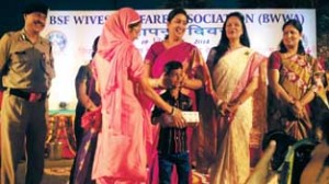 Union HRD Minister Smriti Irani facilitating disable children & widows of BSF men at a function in Delhi.