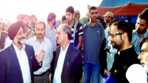 Chairman SLSA, Justice Varinder Singh and Justice Ali Mohammad Margay interacting with flood victims on Saturday.