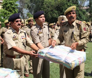 DIG Jammu Shakeel Ahmed handing over relief material to  cop for distribution in flood affected area.