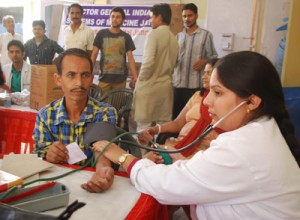 A doctor examining a patient during a medical camp organized by RMWC at Jammu.
