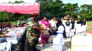 Army officer presenting books to students at Poonch on Sunday. 