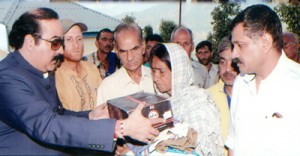 MLC Ajatshatru providing relief items to a flood victim at village Panjar in Udhampur district.