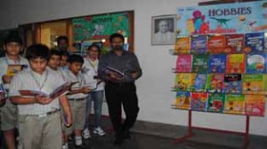 Students of KCIS exploring books during a book exhibition at Jammu on Wednesday. 