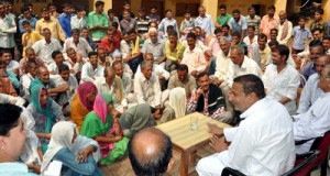 Minister for PHE, Sham Lal Sharma interacting with flood affected people at Akhnoor on Thursday.