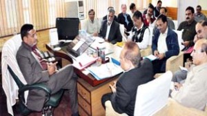 Minister for PHE, Sham Lal Sharma chairing a meeting of officers at Srinagar on Friday.