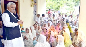 Minister for Planning, Ajay Sadhotra interacting with flood affected people of Marh block on Saturday.