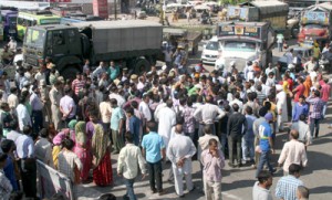 Jammu-Pathankot National Highway blocked during protest at Satwari on Friday.—Excelsior/Rakesh