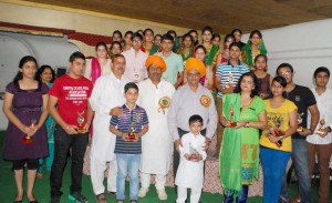 Mahajan youths who were honoured by Mahajan Sabha, Channi Himmat, posing for a group photograph with Minister for Housing Raman Bhalla, at Jammu on Sunday. -Excelsior/ Rakesh