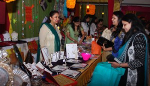 Women having glimpse of jewellery items during Anandotsav Mela at Jammu on Thursday. 